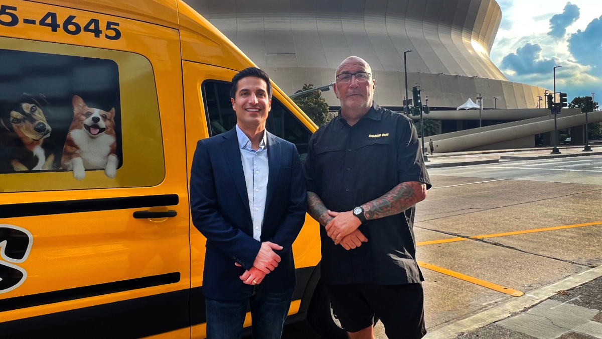 Mario and Troy standing in front of the Doggie Bus